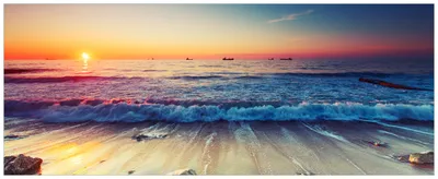 Produktbild von Wallario Wandbild aus Acryl, 125 x 50 cm, freischwebende Optik - Sonnenuntergang am Meer mit Wellen am Strand