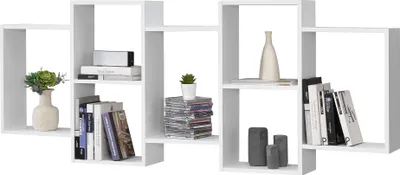 A white modular shelving unit with various items displayed on its shelves.