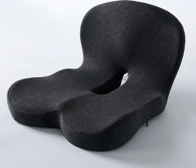 A dark gray ergonomic seat cushion with a cut-out center, designed for office chairs.