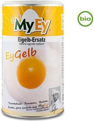 A can of MyEy EyGelb, a vegan egg yolk substitute, is shown against a white background. The can features bright yellow and white branding with images of an egg yolk and a chef.