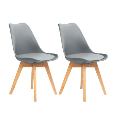 Two gray dining chairs with wooden legs are shown against a white background.