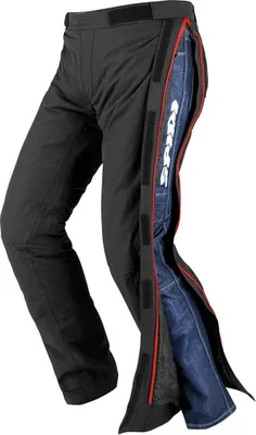A pair of black motorcycle over-pants with blue jeans visible underneath.