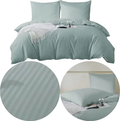 A neatly made bed with sage green striped bedding and two pillows.