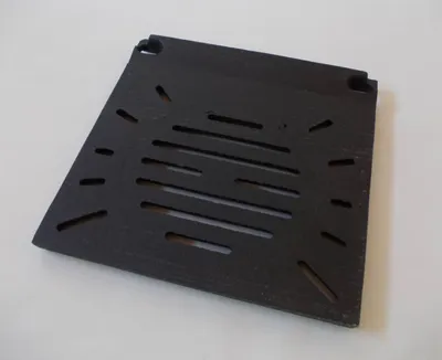 A black metal grate or insert is shown on a white background.