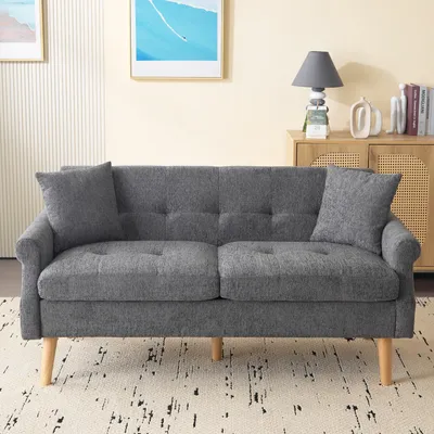 A gray sofa with two throw pillows is shown in a living room setting.