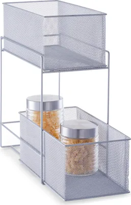 A two-tiered wire mesh storage organizer with two glass jars containing pasta on the lower shelf.