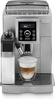 A DeLonghi automatic coffee machine with a glass of cappuccino.
