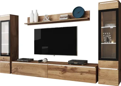 A modern living room media wall unit with a TV, shelves, and cabinets.