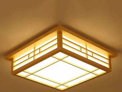 A square ceiling light fixture with a wooden frame and a frosted white diffuser.