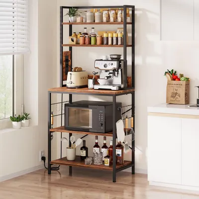 A kitchen baker's rack filled with kitchen appliances and items.