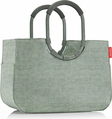 A studio shot of a green shopping bag with gray handles against a white background.