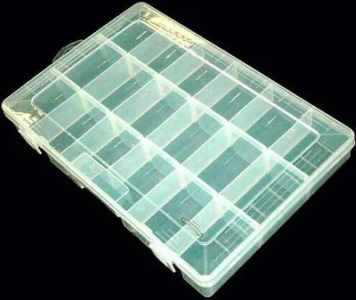A transparent plastic organizer box with multiple compartments, shown against a black background.