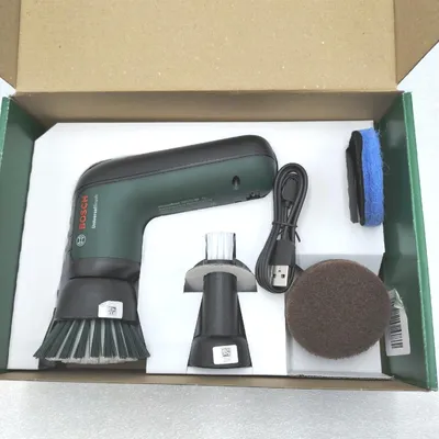 A Bosch UniversalBrush cleaning tool and its accessories are neatly arranged inside a cardboard box.