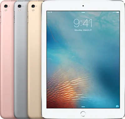 Four iPads are lined up, with the front one displaying a lock screen.