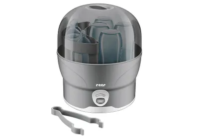A baby bottle sterilizer with a transparent lid and a pair of tongs in front of it.