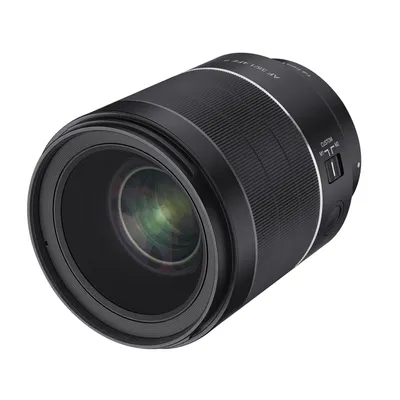 A studio shot of a black camera lens against a white background.