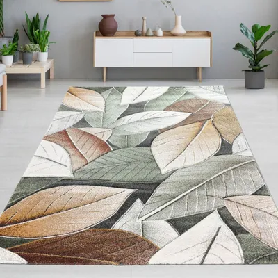 A rug with a leaf pattern is laid out on a floor in a room with furniture and plants.