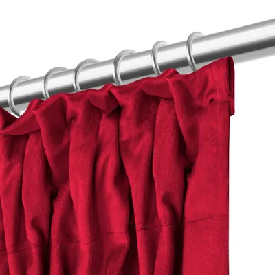 A close-up view of a red curtain hanging from a silver curtain rod.