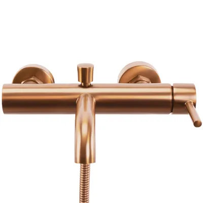 A close-up studio shot of a brushed copper bathtub faucet.