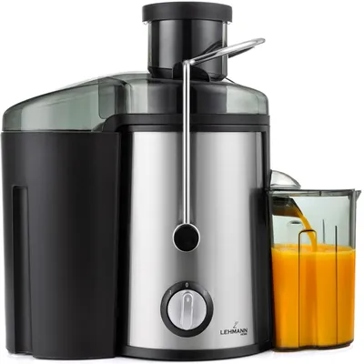 A close-up studio shot of a silver and black juicer, with orange juice being dispensed into a clear jug.