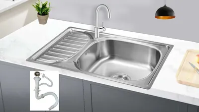 A stainless steel kitchen sink with a drainboard, faucet, and a small inset image of a drain pipe assembly.