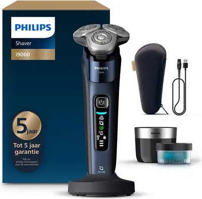 A Philips Shaver i9000 electric razor and its accessories are displayed on a white and blue background, with the product packaging visible on the left.