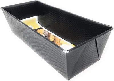 A black loaf pan with a textured exterior, shown from a slightly elevated side angle.