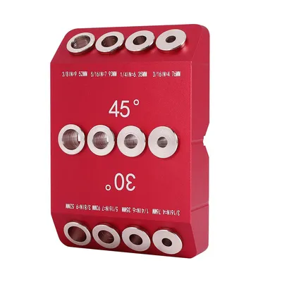 A red metal jig for drilling holes at specific angles.