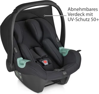 A black baby car seat with green accents, shown from a slightly elevated front-left angle against a white background.