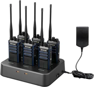A set of six Retevis RT86A walkie-talkies are neatly arranged in a charging dock. A power adapter is connected to the dock, and the walkie-talkies have their antennas extended.