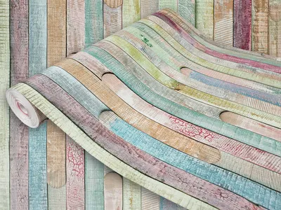 A roll of colorful wood-patterned wallpaper is displayed partially unrolled, showcasing its texture and design against a matching wall.