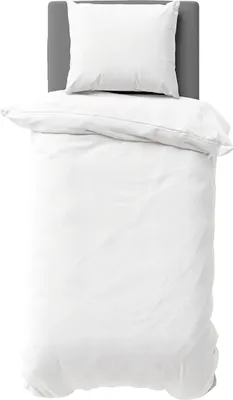 A white duvet and pillow are neatly arranged on a bed with a grey headboard.