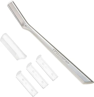 A silver Tweezerman facial razor with three replacement blades and a protective cap, all on a white background.
