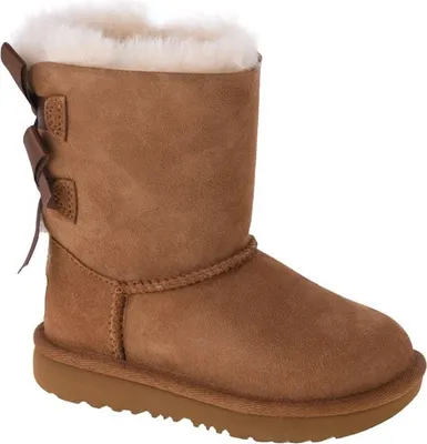 A single brown UGG boot with white fur lining and a brown bow detail on the back, isolated on a white background.