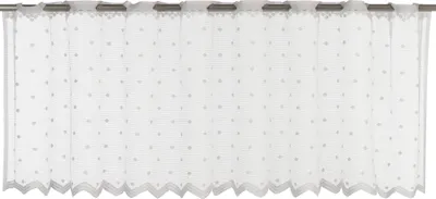 A white sheer curtain with small grey polka dots hanging from a rod.