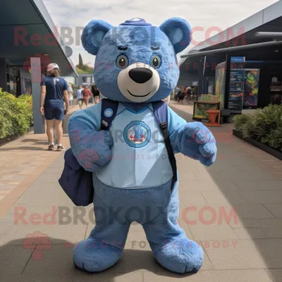Produktbild von Blauer REDBROKOLY Bär als Maskottchen kostüm gekleidet in ein Oxford-Hemd und Rucksäcke