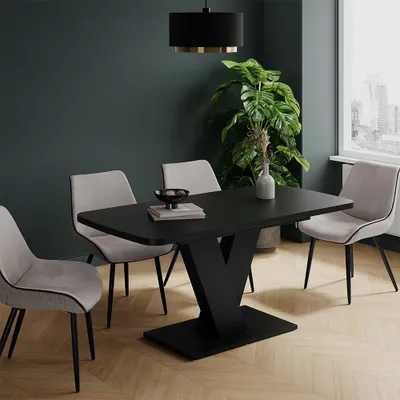 A dining table with chairs in a room.