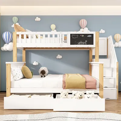 A children's bunk bed with a staircase, drawers, and a chalkboard feature, set against a blue wall decorated with cloud and hot air balloon motifs.