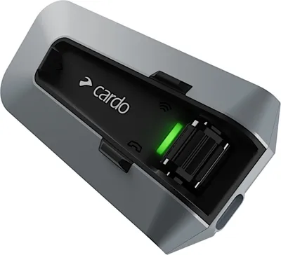A close-up view of a Cardo Packtalk communication system unit.