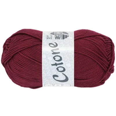 A ball of burgundy yarn with a label.