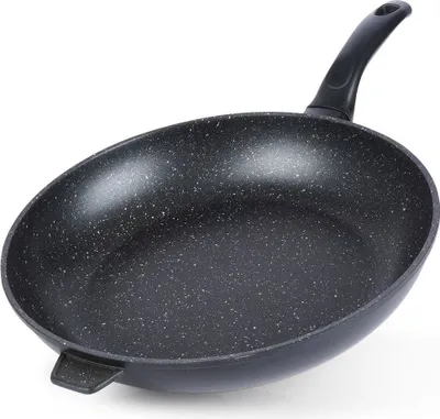 A black frying pan with a speckled interior and a black handle, shown from a side angle against a white background.