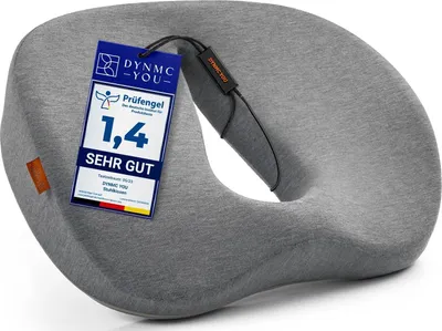 A grey donut-shaped cushion with a tag attached.