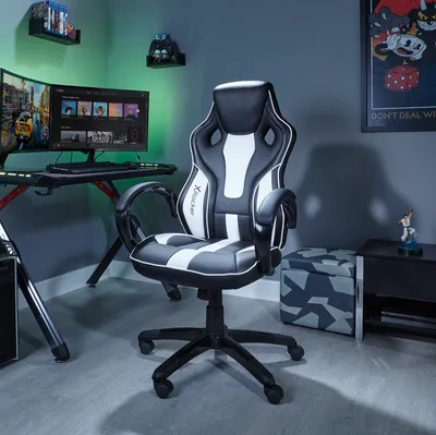 A gaming setup with a chair, desk, and computer.