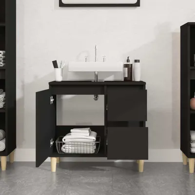 A black bathroom vanity with a white sink and faucet, shown in a room with white walls and gray tiled floor.