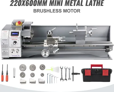 A mini metal lathe with various accessories and a toolbox displayed below it.