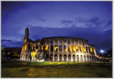 Produktbild von Wallario Wandbild Italien bei Nacht - Kollosseum in Rom, beleuchtet am Abend, Größe: 70,30 x 100,30 cm, Poster mit weißem Kunststoffrahmen