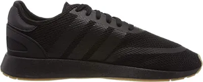 A side view of a black Adidas sneaker.