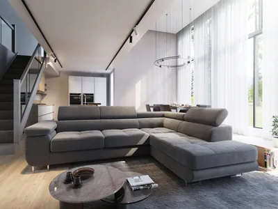 A modern living room with a large sectional sofa, coffee table, and dining area in the background.