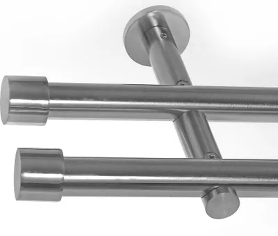 Close-up view of a double curtain rod system with wall mounts.