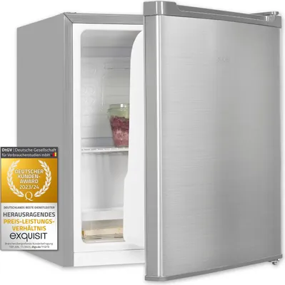 A silver mini refrigerator with its door slightly ajar, showing a jar of food inside. A German customer award badge is affixed to the left side of the refrigerator.